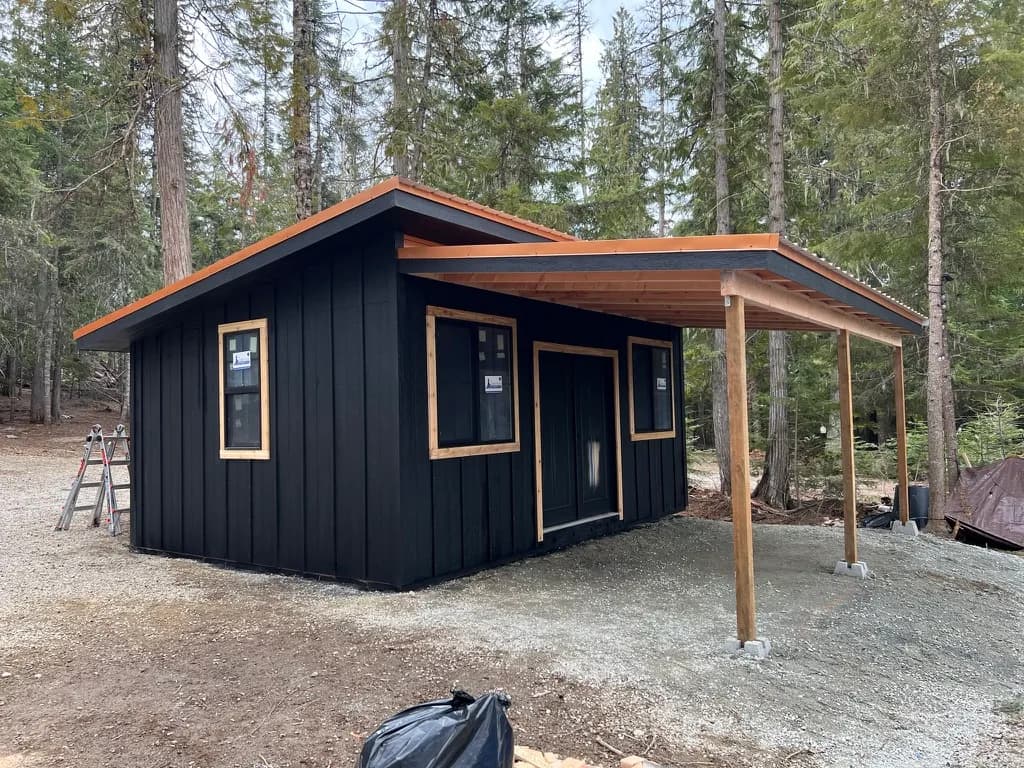 studio shed with lean to and black windows with cedar trim