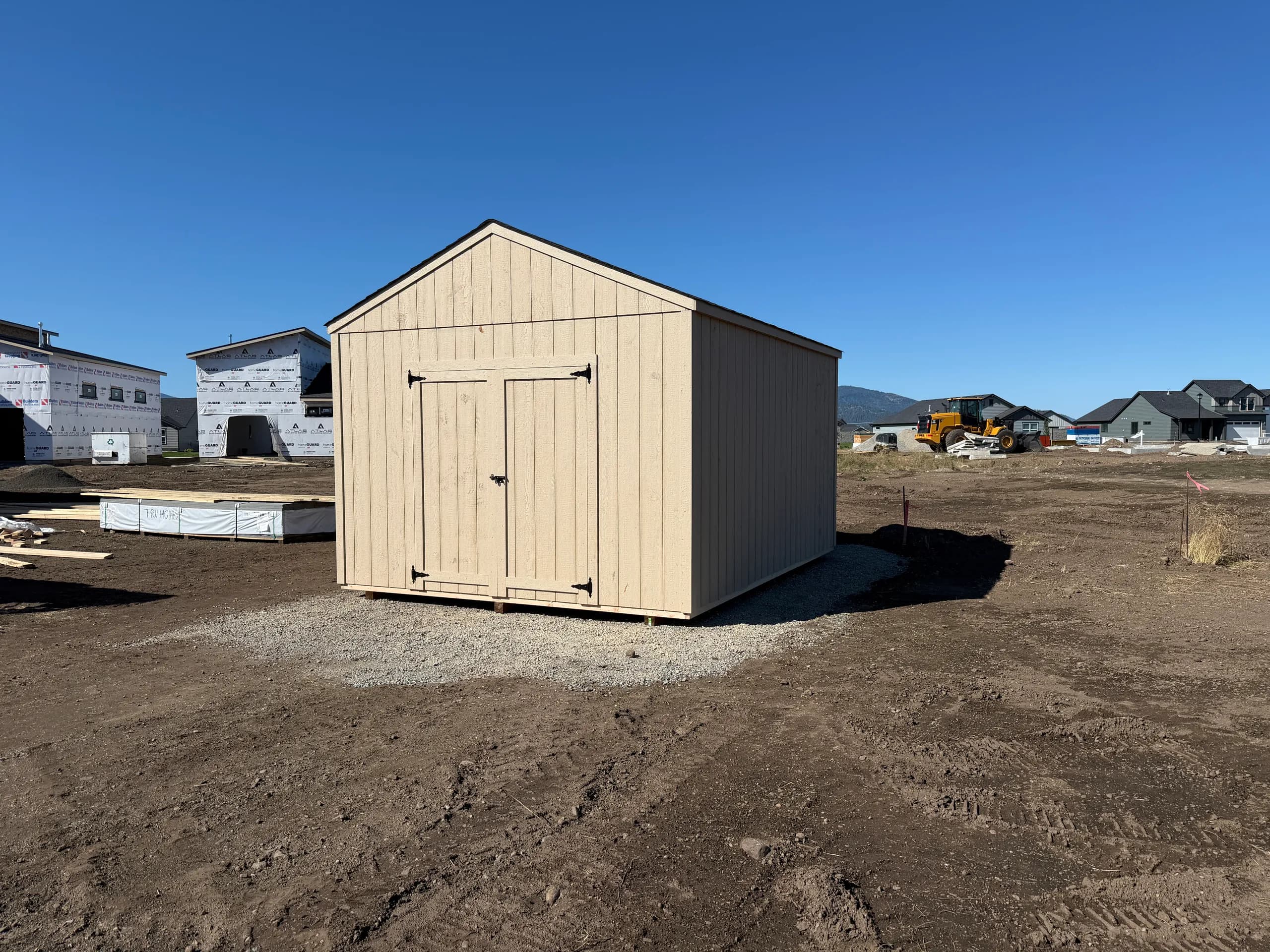 12x16 storage shed on a gravel pad with double doors in Rathdrum