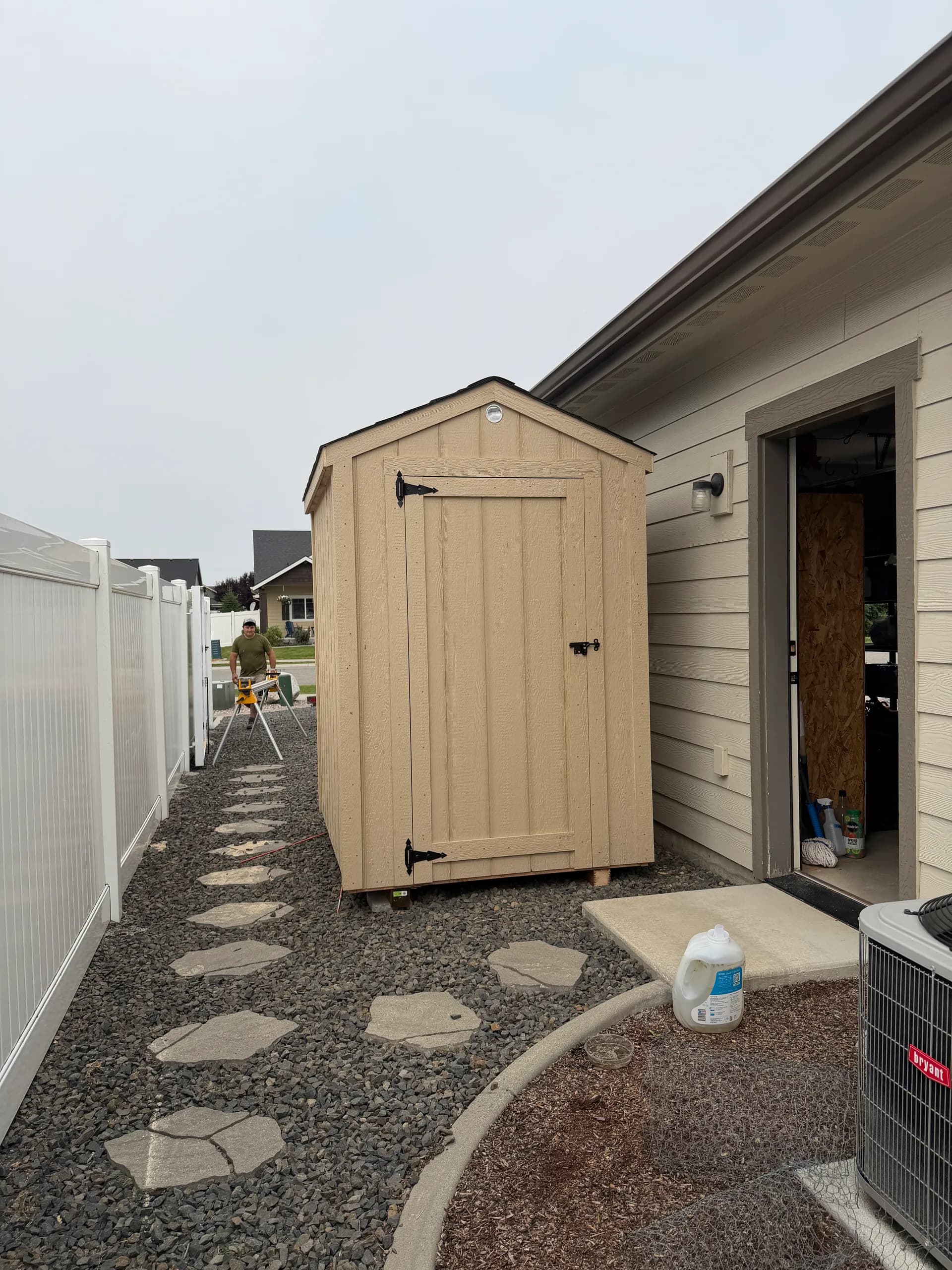 5x6 gable shed with 3' door and comp roofing in a gravel side yard
