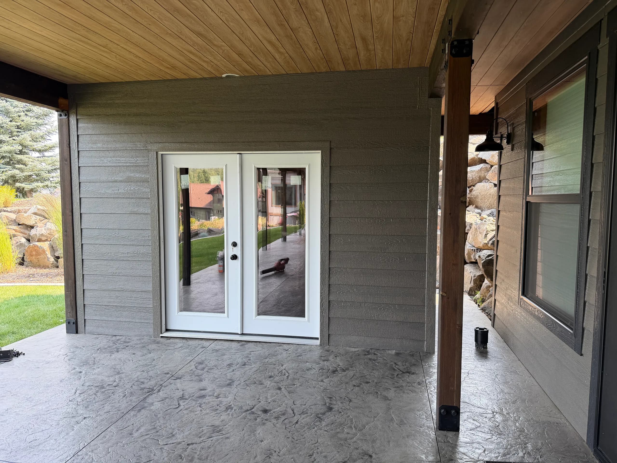 custom shed matches house perfectly and uses 6' glass French doors