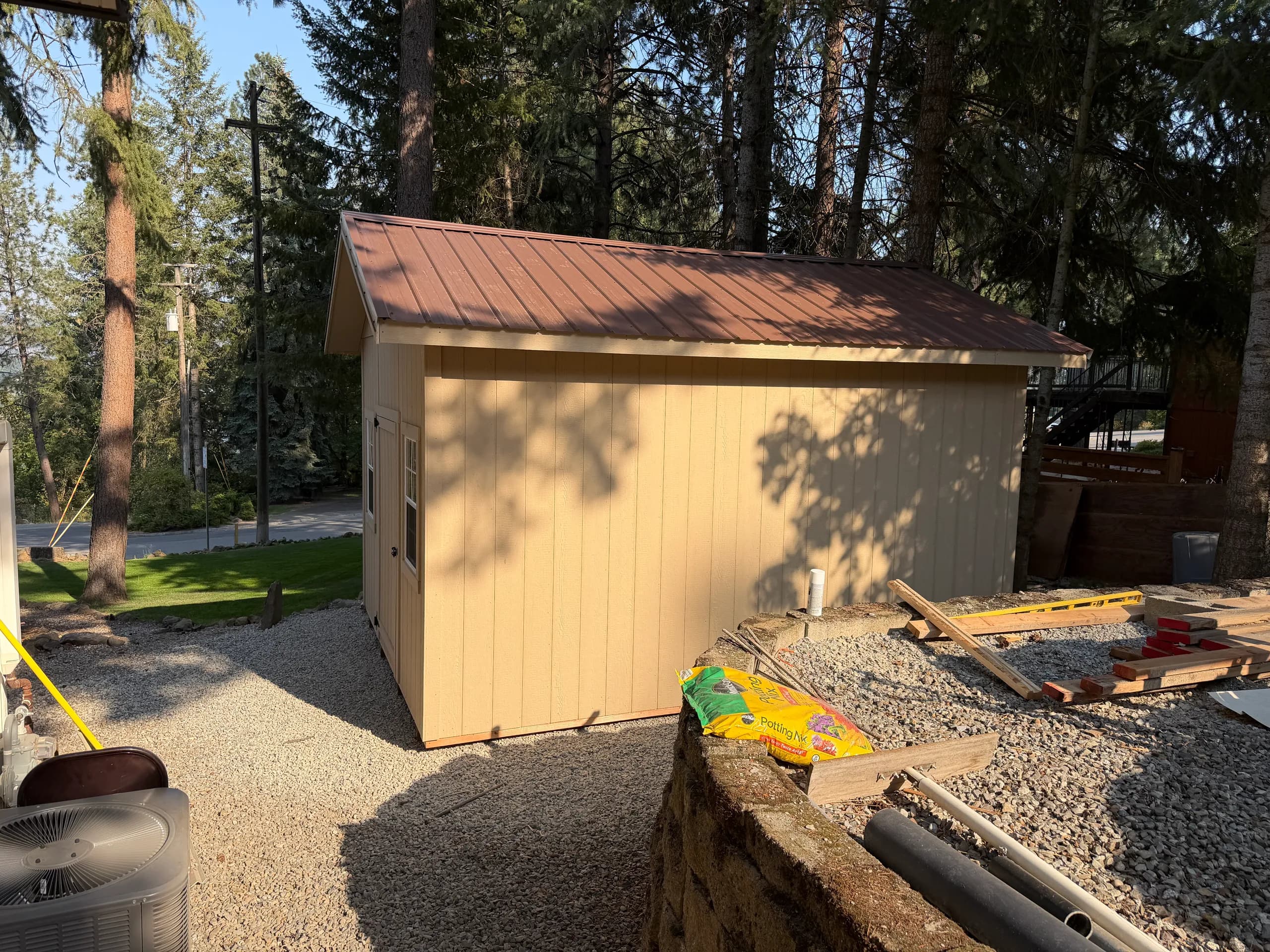 side view of gable storage shed with metal roofing