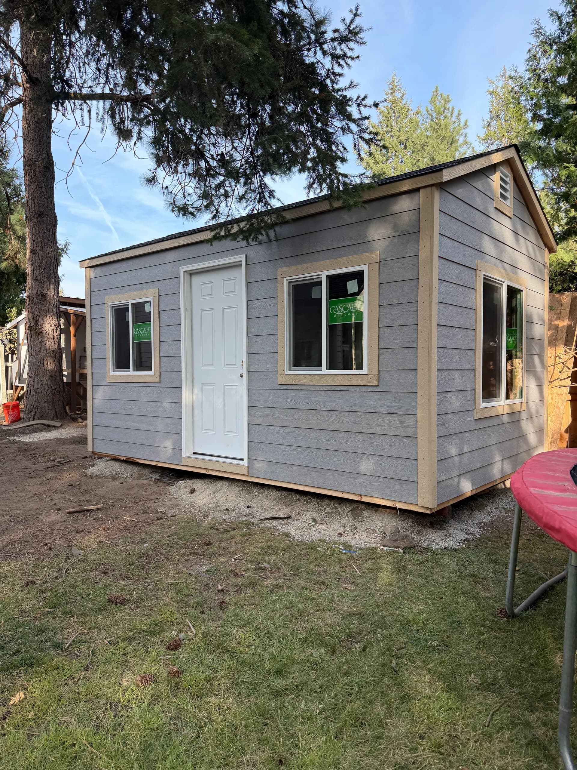 office shed with large windows and lap siding