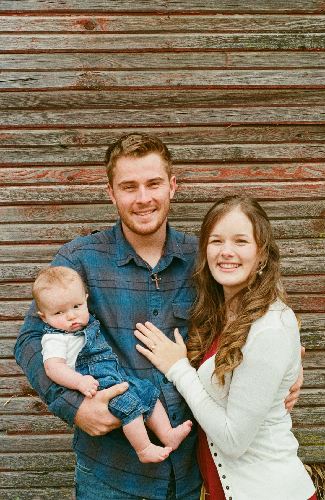 Justice Owens with his family in front of a wood wall