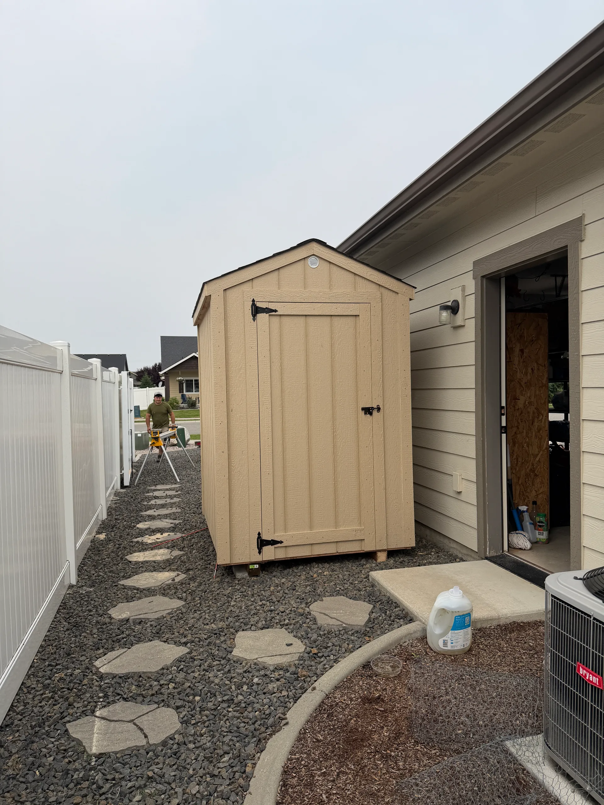5x6 gable shed with 3' door and comp roofing in a gravel side yard