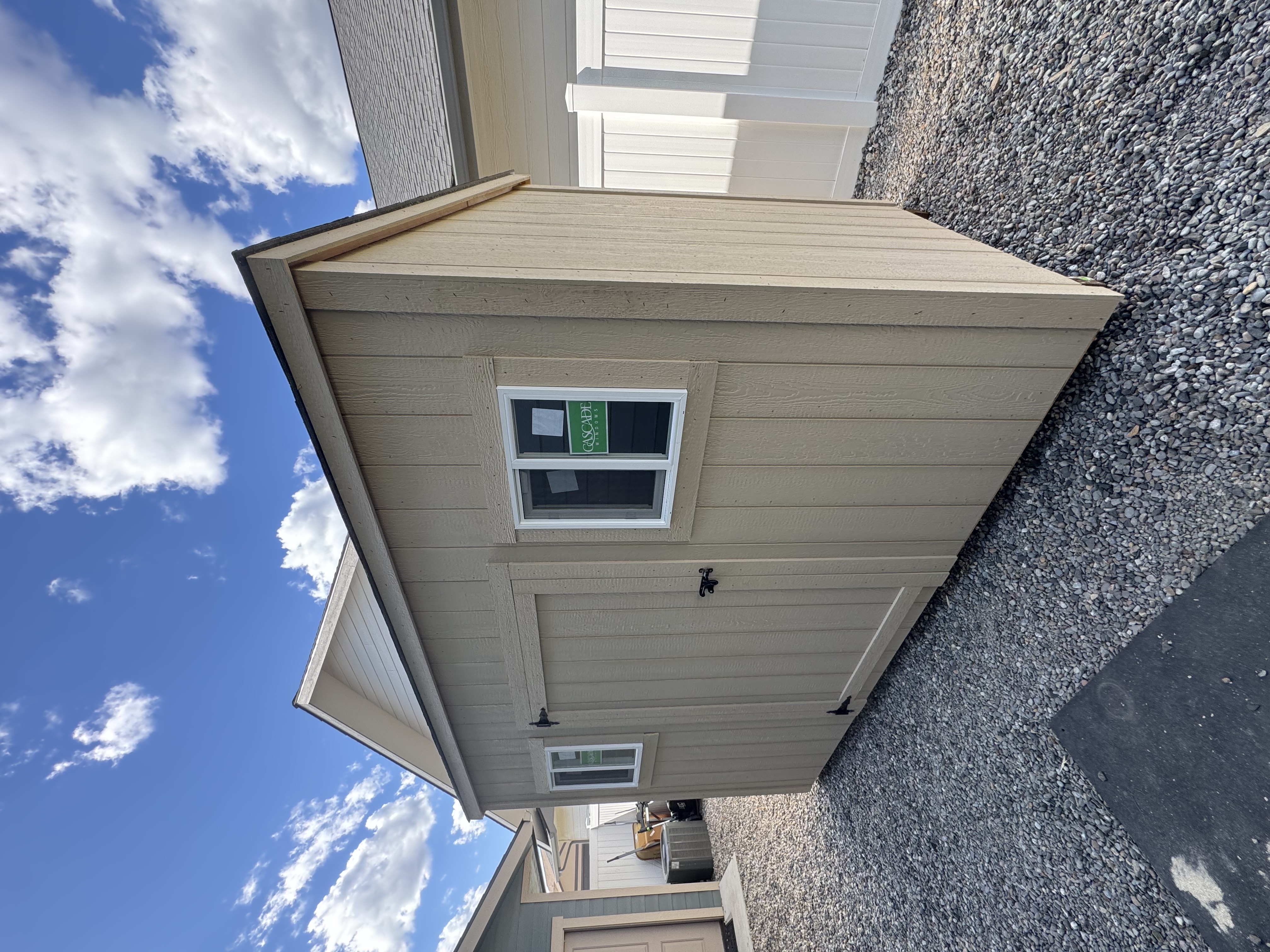 5x12 Mini Modern Shed with door and two windows in a narrow gravel side yard