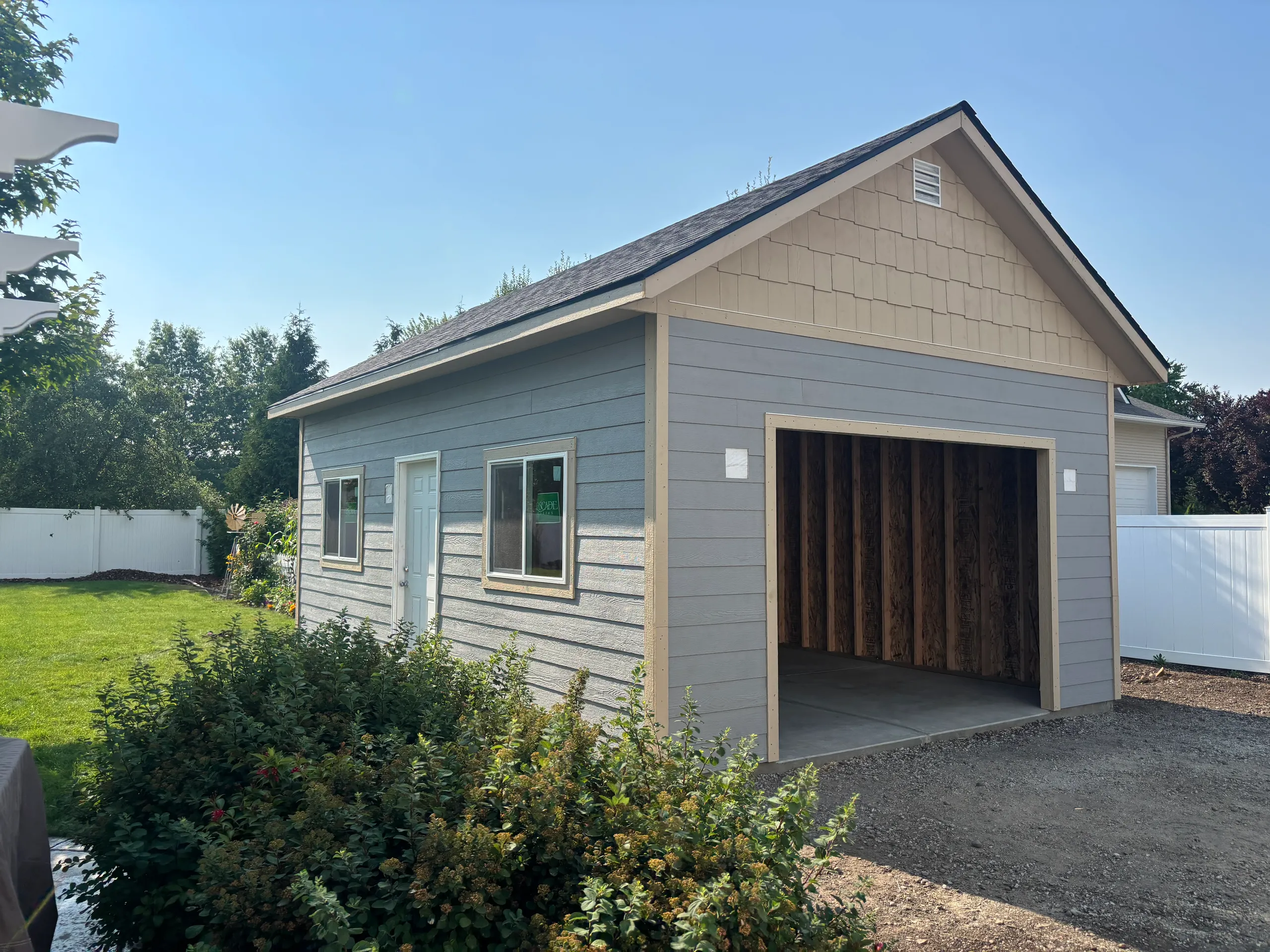 16x24 detached garage with lap siding, garage door, large windows